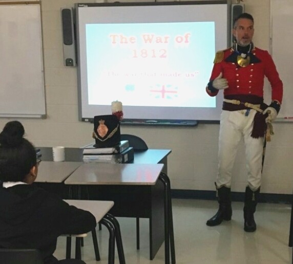 Picture of a teacher standing at the front of the class